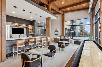 A modern kitchen and dining area with a bar and seating.